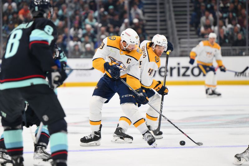 Nov 2, 2023; Seattle, Washington, USA; Nashville Predators defenseman Roman Josi (59) and left wing Kiefer Sherwood (44) play the puck against the Seattle Kraken during the second period at Climate Pledge Arena. Mandatory Credit: Steven Bisig-USA TODAY Sports