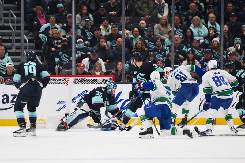 Nov 24, 2023; Seattle, Washington, USA; Vancouver Canucks center Dakota Joshua (81) scores a goal past Seattle Kraken goaltender Joey Daccord (35) during the second period at Climate Pledge Arena. Mandatory Credit: Steven Bisig-USA TODAY Sports