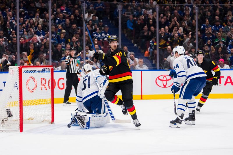 Jan 20, 2024; Vancouver, British Columbia, CAN; Toronto Maple Leafs defenseman Morgan Rielly (44) watches as Vancouver Canucks forward Elias Pettersson (40) celebrates his goal scored on goalie Martin Jones (31) in the third period at Rogers Arena. Canucks won 6-4. Mandatory Credit: Bob Frid-USA TODAY Sports