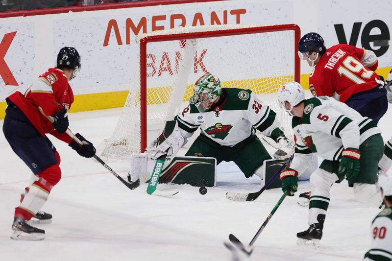 Jan 19, 2024; Sunrise, Florida, USA; Minnesota Wild goaltender Filip Gustavsson (32) makes a save against the Florida Panthers during the third period at Amerant Bank Arena. Mandatory Credit: Sam Navarro-USA TODAY Sports