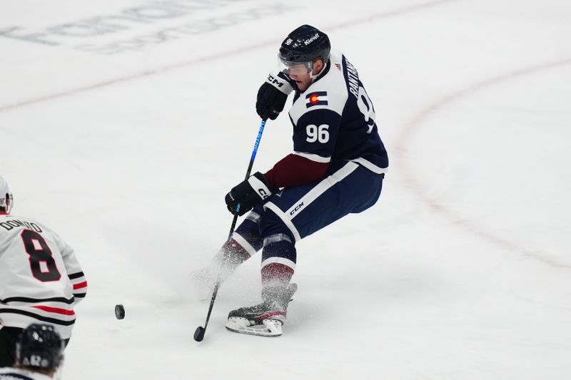 Mar 4, 2024; Denver, Colorado, USA; Colorado Avalanche right wing Mikko Rantanen (96) shoots the puck in the first period against the Chicago Blackhawks at Ball Arena. Mandatory Credit: Ron Chenoy-USA TODAY Sports