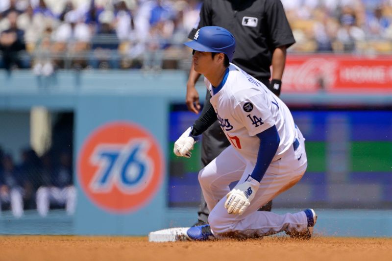 Apr 30, 2025; Los Angeles, California, USA; Los Angeles Dodgers designated hitter Shohei Ohtani (17) slides into second base during the third inning at Dodger Stadium. Mandatory Credit: Jayne Kamin-Oncea-Imagn Images