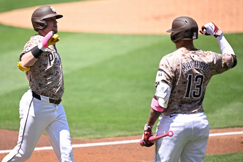 May 12, 2024; San Diego, California, USA; San Diego Padres first baseman Jake Cronenworth (left) is congratulated by third baseman Manny Machado (13) after hitting a home run against the Los Angeles Dodgers during the first inning at Petco Park. Mandatory Credit: Orlando Ramirez-USA TODAY Sports