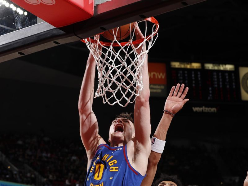 PORTLAND, OR - MARCH 23: Christian Braun #0 of the Denver Nuggets dunks the ball during the game against the Portland Trail Blazers on March 23, 2024 at the Moda Center Arena in Portland, Oregon. NOTE TO USER: User expressly acknowledges and agrees that, by downloading and or using this photograph, user is consenting to the terms and conditions of the Getty Images License Agreement. Mandatory Copyright Notice: Copyright 2024 NBAE (Photo by Cameron Browne/NBAE via Getty Images)