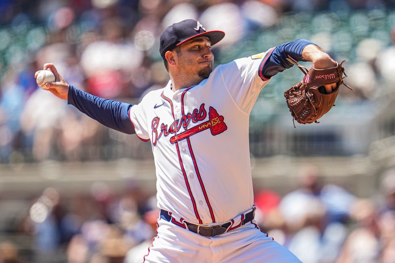 Aug 25, 2024; Cumberland, Georgia, USA; Atlanta Braves relief pitcher Luke Jackson (22) pitches against the Washington Nationals during the seventh inning at Truist Park. Mandatory Credit: Dale Zanine-USA TODAY Sports