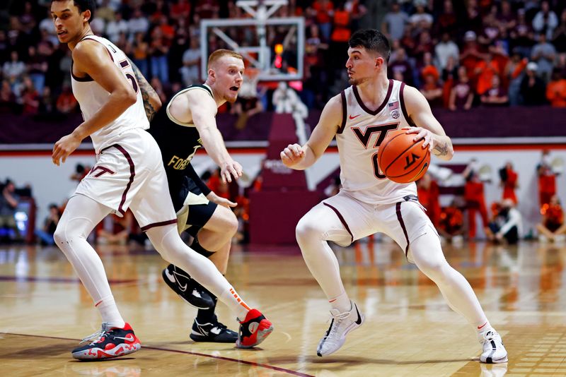 Mar 2, 2024; Blacksburg, Virginia, USA; Virginia Tech Hokies guard Hunter Cattoor (0) handles the ball against Wake Forest Demon Deacons guard Cameron Hildreth (2) during the second half at Cassell Coliseum. Mandatory Credit: Peter Casey-USA TODAY Sports
