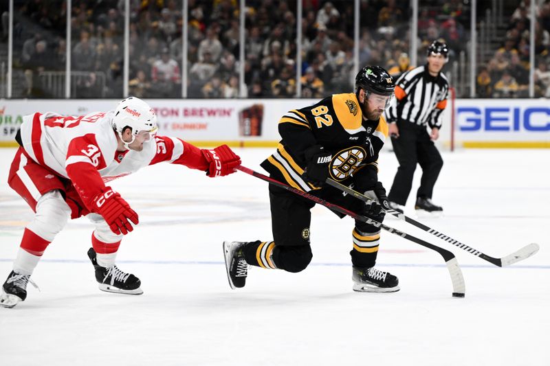 Dec 3, 2024; Boston, Massachusetts, USA; Boston Bruins defenseman Jordan Oesterle (82) skates against Detroit Red Wings right wing Christian Fischer (36) during the first period at the TD Garden. Mandatory Credit: Brian Fluharty-Imagn Images