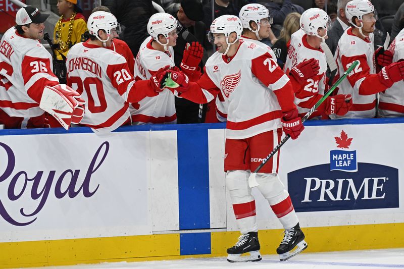 Oct 13, 2025; Toronto, Ontario, CAN; Detroit Red Wings left wing James van Riemsdyk (21) celebrates a goal at the bench in the third period against the Toronto Maple Leafs at Scotiabank Arena. Mandatory Credit: Gerry Angus-Imagn Images