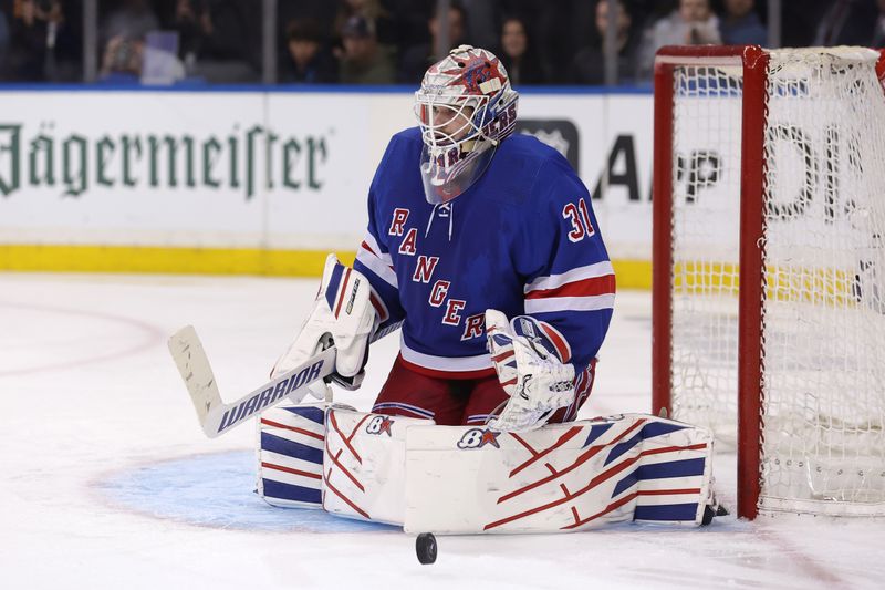 May 13, 2024; New York, New York, USA; New York Rangers goaltender Igor Shesterkin (31) makes a save against the Carolina Hurricanes during the third period of game five of the second round of the 2024 Stanley Cup Playoffs at Madison Square Garden. Mandatory Credit: Brad Penner-USA TODAY Sports