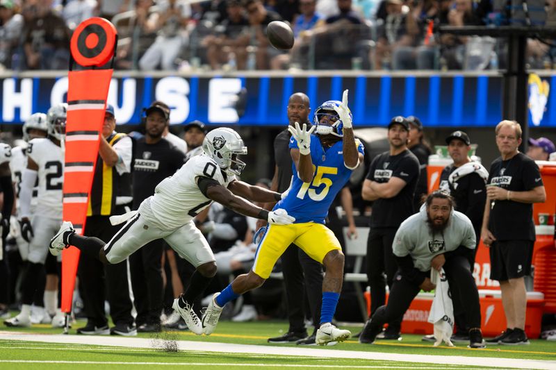 Los Angeles Rams wide receiver Demarcus Robinson (15) catches the ball over Las Vegas Raiders cornerback Jakorian Bennett (0) during an NFL football game, Sunday, Oct. 20, 2024, in Inglewood, Calif. (AP Photo/Kyusung Gong)