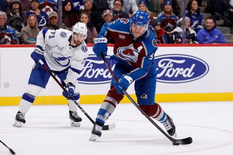 Oct 30, 2024; Denver, Colorado, USA; Colorado Avalanche right wing Mikko Rantanen (96) controls the puck ahead of Tampa Bay Lightning center Anthony Cirelli (71) in the second period at Ball Arena. Mandatory Credit: Isaiah J. Downing-Imagn Images