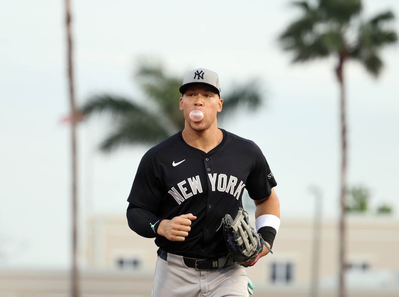Mar 20, 2025; Sarasota, Florida, USA; New York Yankees outfielder Aaron Judge (99) runs back to the dugout at the end of the first inning against the Baltimore Orioles at Ed Smith Stadium. Mandatory Credit: Kim Klement Neitzel-Imagn Images