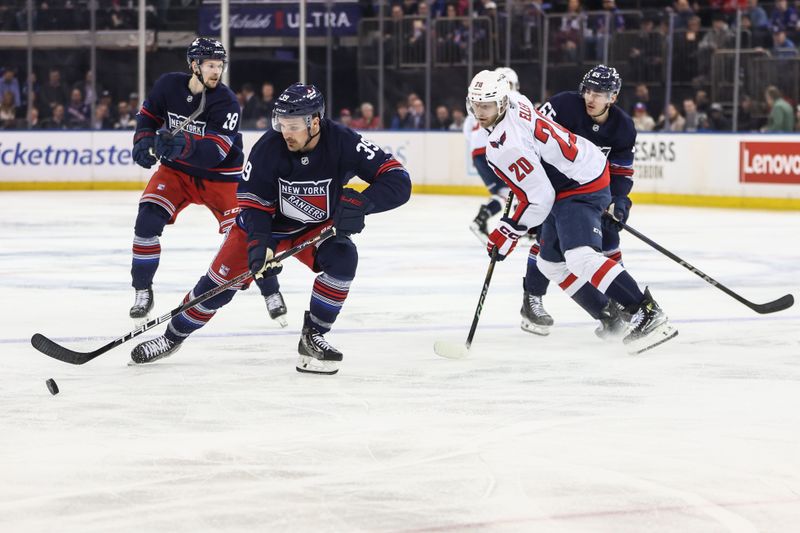 Mar 5, 2025; New York, New York, USA;  New York Rangers center Sam Carrick (39) and Washington Capitals center Lars Eller (20) chase the puck in the first period at Madison Square Garden. Mandatory Credit: Wendell Cruz-Imagn Images