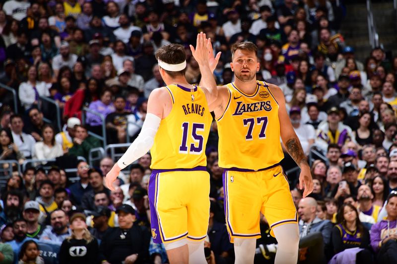 LOS ANGELES, CA - FEBRUARY 27: Austin Reaves #15 and Luka Doncic #77 of the Los Angeles Lakers high five during the game against the Minnesota Timberwolves on February 27, 2025 at Crypto.Com Arena in Los Angeles, California. NOTE TO USER: User expressly acknowledges and agrees that, by downloading and/or using this Photograph, user is consenting to the terms and conditions of the Getty Images License Agreement. Mandatory Copyright Notice: Copyright 2025 NBAE (Photo by Adam Pantozzi/NBAE via Getty Images)