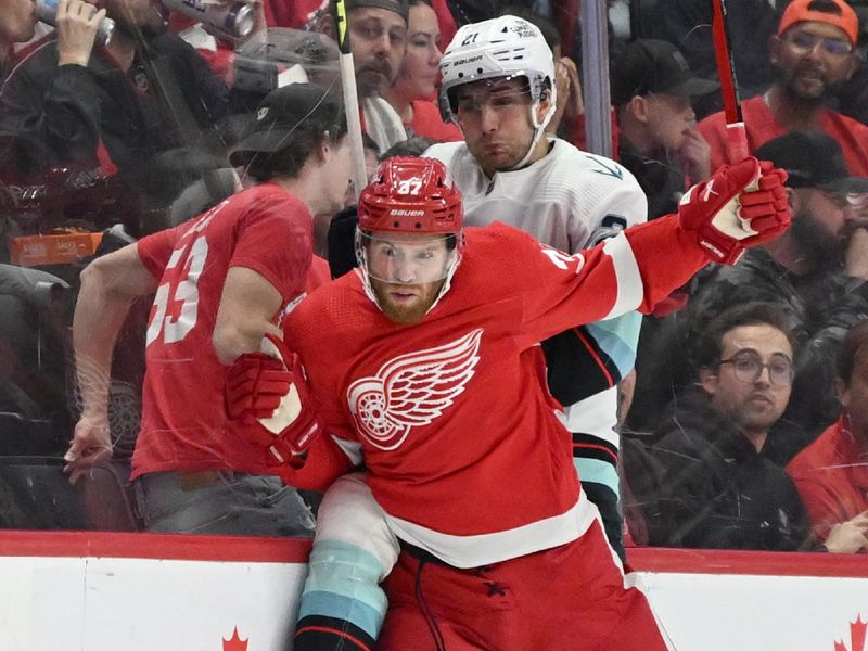 Oct 24, 2023; Detroit, Michigan, USA; Detroit Red Wings left wing J.T. Compher (37) and Seattle Kraken center Alex Wennberg (21) collide along the boards in the first period at Little Caesars Arena. Mandatory Credit: Lon Horwedel-USA TODAY Sports