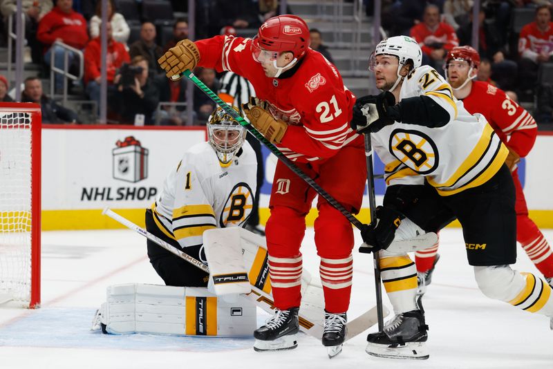 Dec 2, 2025; Detroit, Michigan, USA;  Detroit Red Wings left wing James van Riemsdyk (21) and Boston Bruins defenseman Andrew Peeke (26) fight for position in front of goaltender Jeremy Swayman (1) in the second period at Little Caesars Arena. Mandatory Credit: Rick Osentoski-Imagn Images