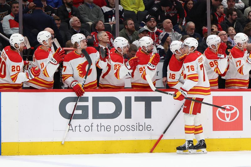 Feb 25, 2025; Washington, District of Columbia, USA; Calgary Flames center Martin Pospisil (76) celebrates with teammates after scoring a goal against the Washington Capitals in the first period at Capital One Arena. Mandatory Credit: Geoff Burke-Imagn Images