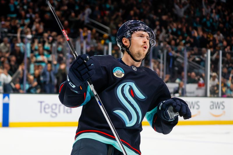 Feb 26, 2024; Seattle, Washington, USA; Seattle Kraken right wing Kailer Yamamoto (56) celebrates after scoring a goal against the Boston Bruins during an overtime shootout at Climate Pledge Arena. Mandatory Credit: Joe Nicholson-USA TODAY Sports