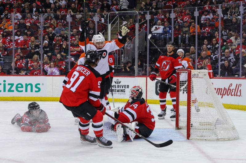 Jan 18, 2025; Newark, New Jersey, USA; Philadelphia Flyers right wing Bobby Brink (10) scores a goal on New Jersey Devils goaltender Jake Allen (34) during the third period at Prudential Center. Mandatory Credit: Ed Mulholland-Imagn Images