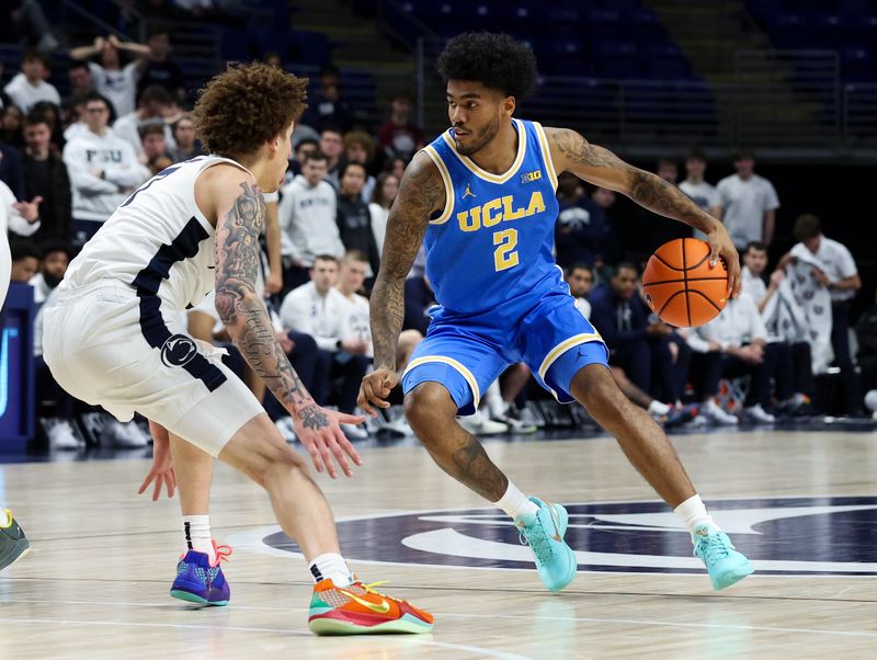 Jan 14, 2026; University Park, Pennsylvania, USA; UCLA Bruins guard Donovan Dent (2) dribbles the ball as Penn State Nittany Lions guard Dominick Stewart (7) defends during the second half at Bryce Jordan Center. Mandatory Credit: Matthew O'Haren-Imagn Images