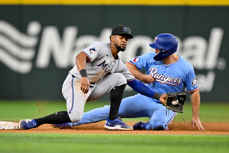 Sep 21, 2025; Arlington, Texas, USA; Texas Rangers left fielder Wyatt Langford (36) steals second base past Miami Marlins shortstop Otto Lopez (6) during the sixth inning at Globe Life Field. Mandatory Credit: Jerome Miron-Imagn Images