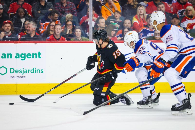 Apr 6, 2024; Calgary, Alberta, CAN; Calgary Flames left wing Dryden Hunt (15) and Edmonton Oilers center Ryan Nugent-Hopkins (93) battles for the puck during the second period at Scotiabank Saddledome. Mandatory Credit: Sergei Belski-USA TODAY Sports