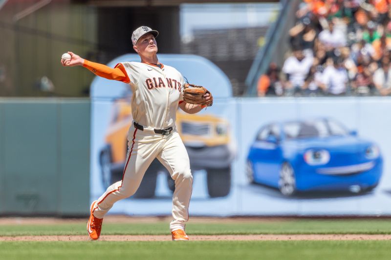 May 18, 2025; San Francisco, California, USA; San Francisco Giants third base Matt Chapman (26) makes a play at first during the fifth inning against the Oakland Athletics at Oracle Park. Mandatory Credit: Bob Kupbens-Imagn Images