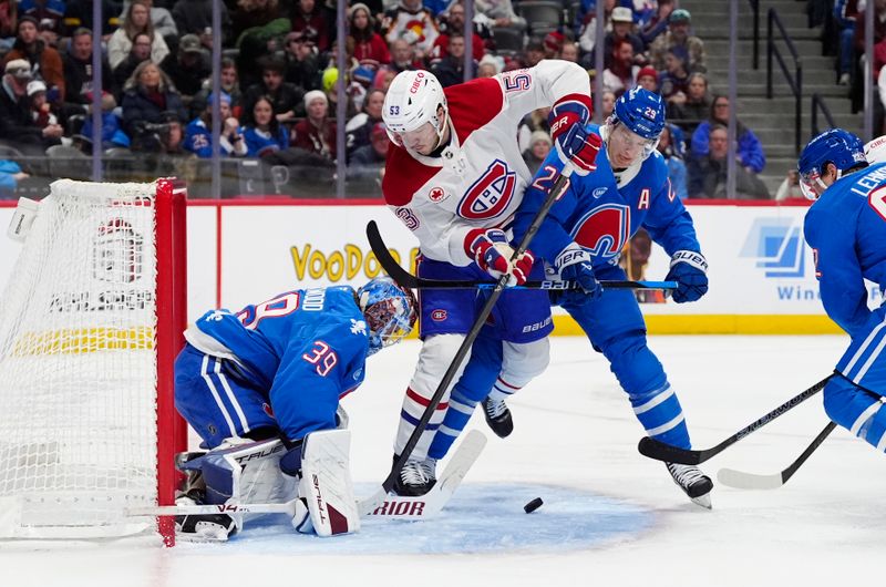 Nov 29, 2025; Denver, Colorado, USA; Colorado Avalanche goaltender Mackenzie Blackwood (39) and center Nathan MacKinnon (29) defend on Montreal Canadiens defenseman Noah Dobson (53) in the third period at Ball Arena. Mandatory Credit: Ron Chenoy-Imagn Images