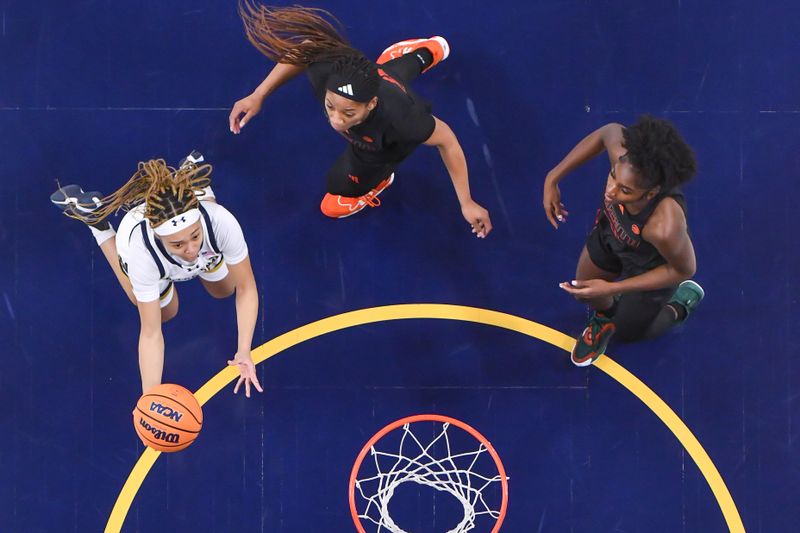 Jan 14, 2024; South Bend, Indiana, USA; Notre Dame Fighting Irish guard Hannah Hidalgo (3) goes up for a shot in front of Miami Hurricanes guard Jasmyne Roberts (4) and guard Jaida Patrick (5) in the first half at the Purcell Pavilion. Mandatory Credit: Matt Cashore-USA TODAY Sports