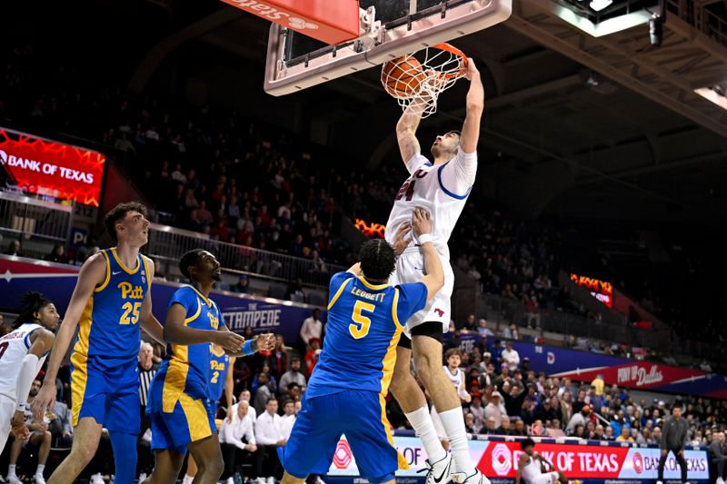 Feb 11, 2025; Dallas, Texas, USA; Southern Methodist Mustangs center Samet Yigitoglu (24) dunks the ball over Pittsburgh Panthers guard Ishmael Leggett (5) during the second half at Moody Coliseum. Mandatory Credit: Jerome Miron-Imagn Images