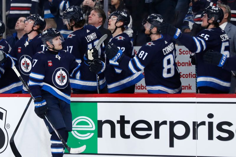 Apr 4, 2024; Winnipeg, Manitoba, CAN; Winnipeg Jets left wing Nikolaj Ehlers (27) celebrates his first period goal against the Calgary Flames at Canada Life Centre. Mandatory Credit: James Carey Lauder-USA TODAY Sports