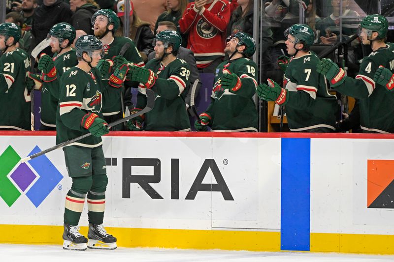 Mar 19, 2025; Saint Paul, Minnesota, USA;  Minnesota Wild forward Matt Boldy (12) celebrates his empty net goal against the Seattle Kraken during the third period at Xcel Energy Center. Mandatory Credit: Nick Wosika-Imagn Images