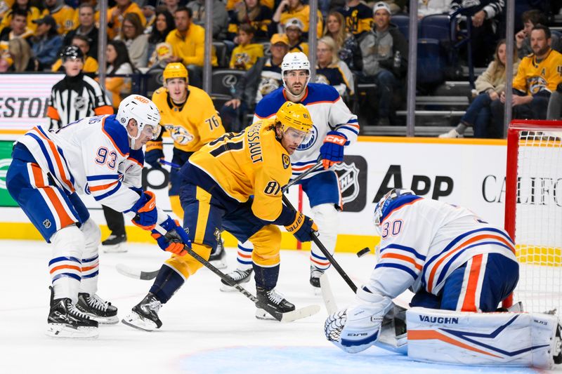 Oct 31, 2024; Nashville, Tennessee, USA;  Edmonton Oilers goaltender Calvin Pickard (30) blocks the shot of Nashville Predators center Jonathan Marchessault (81) during the third period at Bridgestone Arena. Mandatory Credit: Steve Roberts-Imagn Images