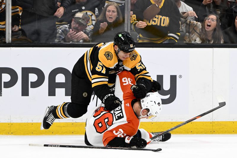 Oct 29, 2024; Boston, Massachusetts, USA; Boston Bruins center Matthew Poitras (51) fights Philadelphia Flyers defenseman Emil Andrae (36) during the third period at TD Garden. Mandatory Credit: Brian Fluharty-Imagn Images