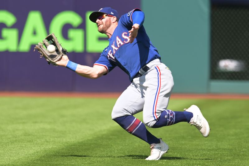 Sep 17, 2023; Cleveland, Ohio, USA; Texas Rangers right fielder Robbie Grossman (4) catches a ball hit by Cleveland Guardians center fielder Ramon Laureano (not pictured) during the first inning at Progressive Field. Mandatory Credit: Ken Blaze-USA TODAY Sports