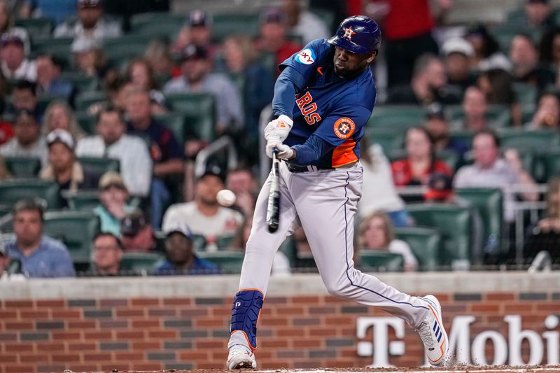 Apr 22, 2023; Cumberland, Georgia, USA; Houston Astros designated hitter Yordan Alvarez (44) hits a two run home run against the Atlanta Braves during the sixth inning at Truist Park. Mandatory Credit: Dale Zanine-USA TODAY Sports