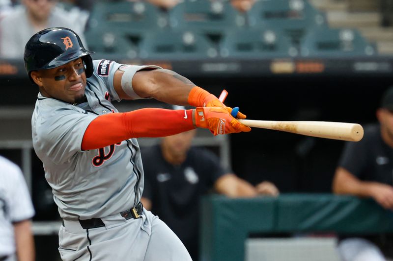 Aug 24, 2024; Chicago, Illinois, USA; Detroit Tigers second baseman Andy Ibanez (77) hits an RBI-single against the Chicago White Sox during the first inning at Guaranteed Rate Field. Mandatory Credit: Kamil Krzaczynski-USA TODAY Sports