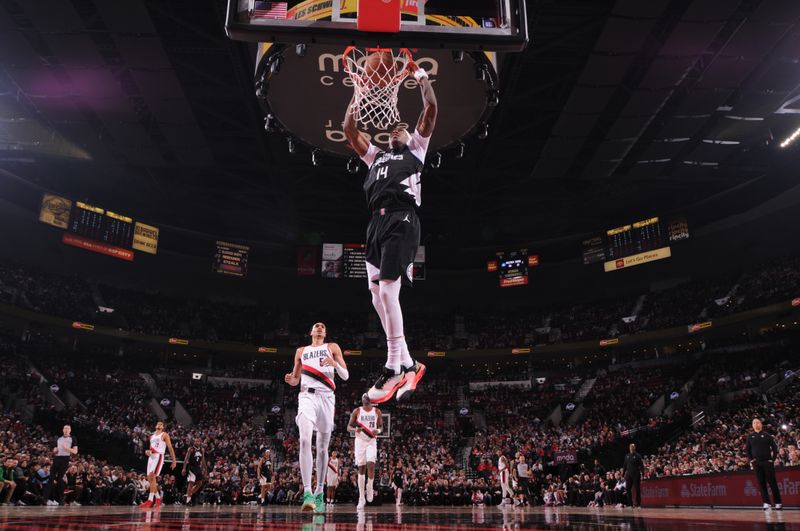 PORTLAND, OR - MARCH 22:  Terance Mann #14 of the LA Clippers slam dunk during the game  on March 22, 2024 at the Moda Center Arena in Portland, Oregon. NOTE TO USER: User expressly acknowledges and agrees that, by downloading and or using this photograph, user is consenting to the terms and conditions of the Getty Images License Agreement. Mandatory Copyright Notice: Copyright 2024 NBAE (Photo by Cameron Browne/NBAE via Getty Images)