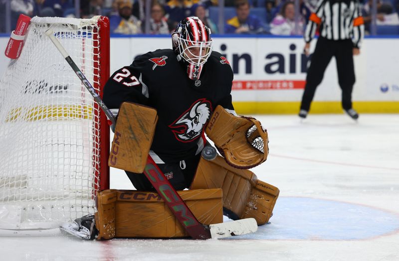 Nov 1, 2024; Buffalo, New York, USA;  Buffalo Sabres goaltender Devon Levi (27) makes a save during the third period against the New York Islanders at KeyBank Center. Mandatory Credit: Timothy T. Ludwig-Imagn Images