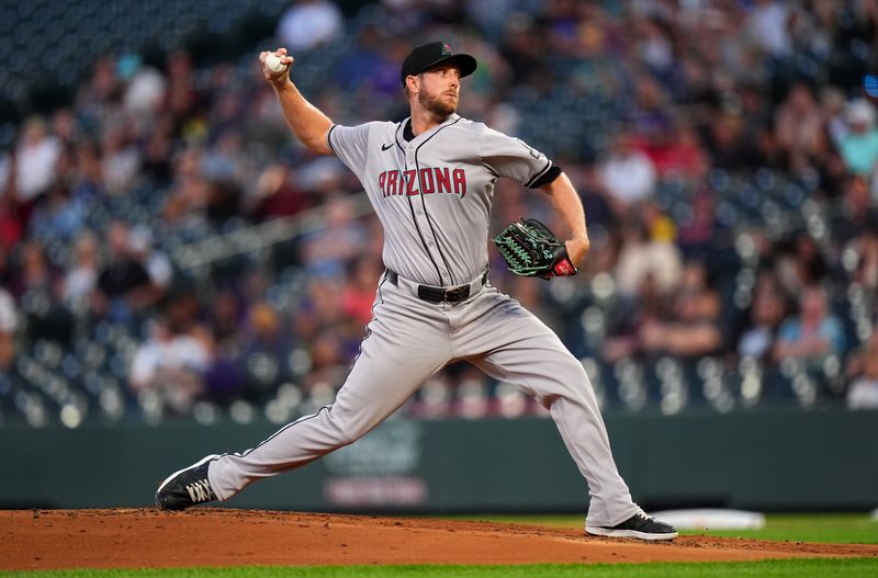 Sep 16, 2024; Denver, Colorado, USA;  Arizona Diamondbacks starting pitcher Merrill Kelly (29) delivers a pitch in the first inning against the Colorado Rockies at Coors Field. Mandatory Credit: Ron Chenoy-Imagn Images