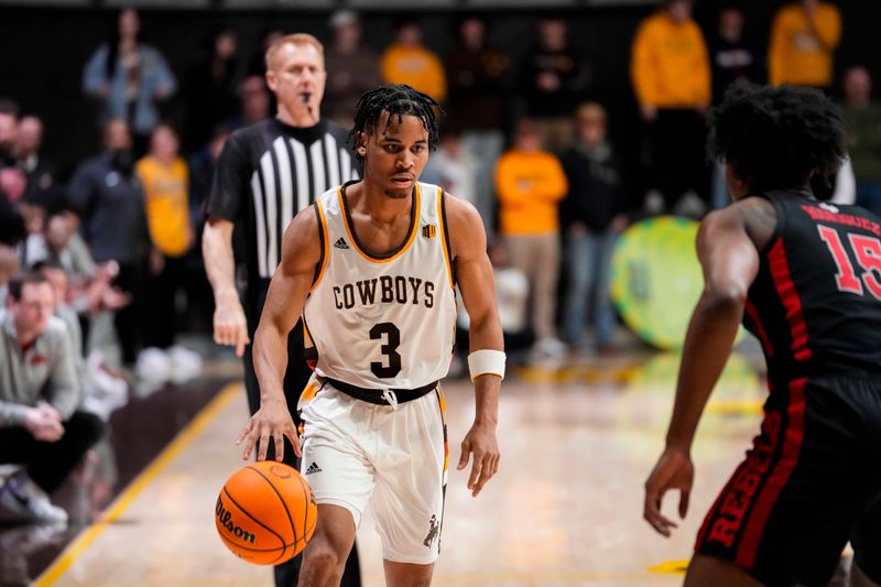 Feb 27, 2024; Laramie, Wyoming, USA; Wyoming Cowboys guard Sam Griffin (3) looks to drive against UNLV Runnin' Rebels center Luis Rodriguez (15) during overtime at Arena-Auditorium. Mandatory Credit: Troy Babbitt-USA TODAY Sports