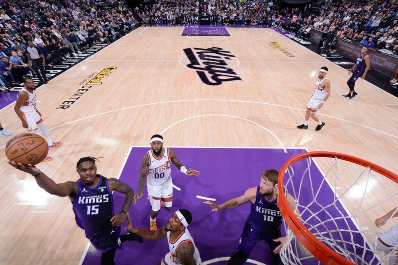 SACRAMENTO, CA - APRIL 12: Davion Mitchell #15 of the Sacramento Kings drives to the basket during the game against the Phoenix Suns on April 12, 2024 at Golden 1 Center in Sacramento, California. NOTE TO USER: User expressly acknowledges and agrees that, by downloading and or using this Photograph, user is consenting to the terms and conditions of the Getty Images License Agreement. Mandatory Copyright Notice: Copyright 2024 NBAE (Photo by Rocky Widner/NBAE via Getty Images)