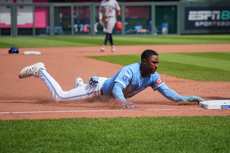 Apr 10, 2025; Kansas City, Missouri, USA; Kansas City Royals shortstop Tyler Tolbert (2) slides into third base against the Minnesota Twins in the eighth inning at Kauffman Stadium. Mandatory Credit: Denny Medley-Imagn Images