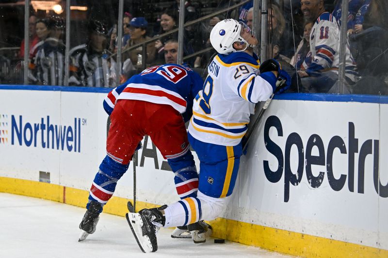 Nov 7, 2024; New York, New York, USA;  New York Rangers center Sam Carrick (39) checks Buffalo Sabres left wing Beck Malenstyn (29) into the boards during the third period at Madison Square Garden. Mandatory Credit: Dennis Schneidler-Imagn Images