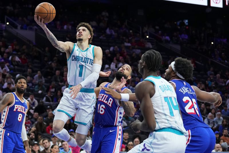 PHILADELPHIA, PENNSYLVANIA - NOVEMBER 10: LaMelo Ball #1 of the Charlotte Hornets shoots the ball against Caleb Martin #16 of the Philadelphia 76ers in the second half at the Wells Fargo Center on November 10, 2024 in Philadelphia, Pennsylvania. The 76ers defeated the Hornets 107-105 in overtime. NOTE TO USER: User expressly acknowledges and agrees that, by downloading and/or using this photograph, user is consenting to the terms and conditions of the Getty Images License Agreement. (Photo by Mitchell Leff/Getty Images)