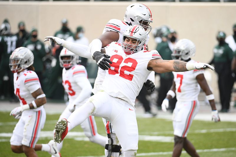 Dec 5, 2020; East Lansing, Michigan, USA; Ohio State Buckeyes defensive tackle Haskell Garrett (92) celebrates a touchdown during the second quarter against the Michigan State Spartans at Spartan Stadium. Mandatory Credit: Tim Fuller-USA TODAY Sports