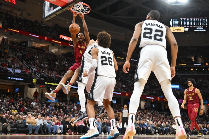 CLEVELAND, OHIO - FEBRUARY 13: Evan Mobley #4 of the Cleveland Cavaliers dunks over Zach Collins #23 and Dominick Barlow #26 of the San Antonio Spurs during the fourth quarter at Rocket Mortgage Fieldhouse on February 13, 2023 in Cleveland, Ohio. The Cavaliers defeated the Spurs 117-109. NOTE TO USER: User expressly acknowledges and agrees that, by downloading and or using this photograph, User is consenting to the terms and conditions of the Getty Images License Agreement. (Photo by Jason Miller/Getty Images)