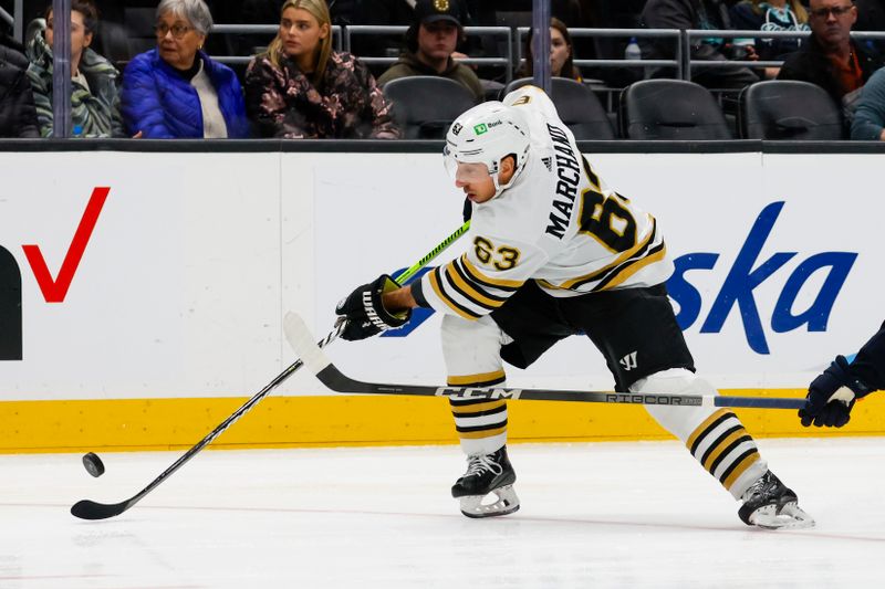 Feb 26, 2024; Seattle, Washington, USA; Boston Bruins left wing Brad Marchand (63) passes the puck against the Seattle Kraken during the second period at Climate Pledge Arena. Mandatory Credit: Joe Nicholson-USA TODAY Sports