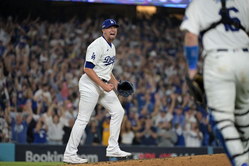 Oct 11, 2024; Los Angeles, California, USA; Los Angeles Dodgers pitcher Blake Treinen (49) celebrates after defeating the San Diego Padres during game five of the NLDS for the 2024 MLB Playoffs at Dodger Stadium. Mandatory Credit: Jayne Kamin-Oncea-Imagn Images