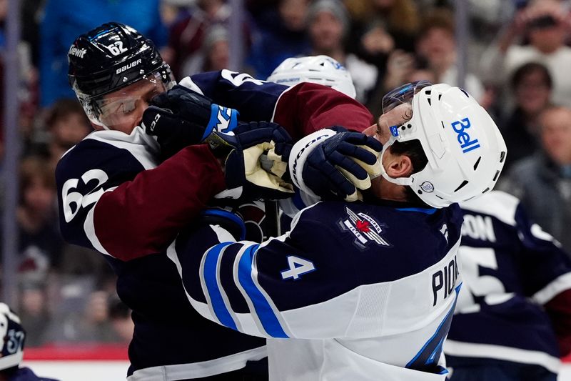 Dec 19, 2025; Denver, Colorado, USA; Winnipeg Jets defenseman Neal Pionk (4) and Colorado Avalanche left wing Artturi Lehkonen (62) fight in the second period at Ball Arena. Mandatory Credit: Ron Chenoy-Imagn Images